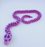 Pink and purple snake-shaped toy on a light blue background