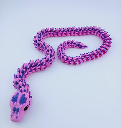 Pink and purple snake-shaped toy on a light blue background