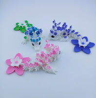 Set of small animal figurines with floral patterns on a white background