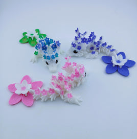 Set of small animal figurines with floral patterns on a white background